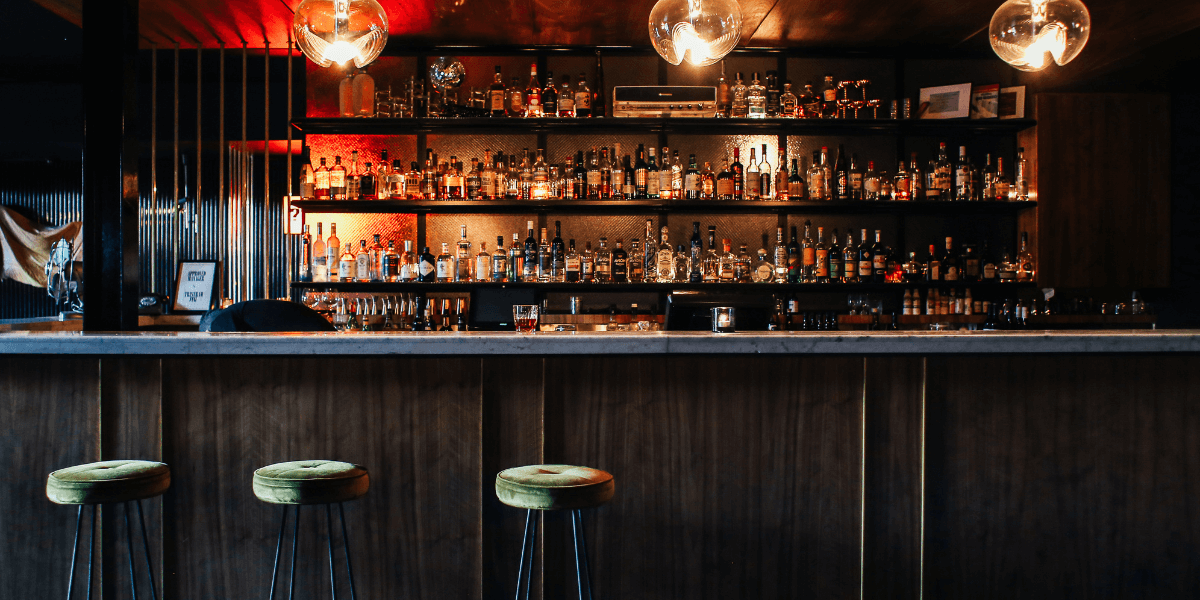 Bar scene with moody lighting and barstools